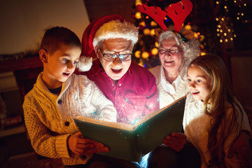 family reading Christmas magic book.