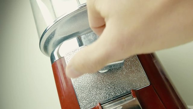 Old retro candy vending machine in use. Inserting a coin.