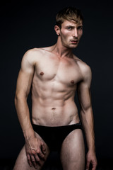 Fototapeta na wymiar handsome young man in underwear posing in studio