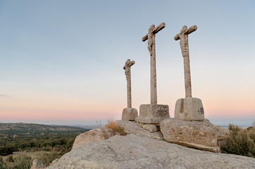 three crosses carved in the stone on fund to the evening