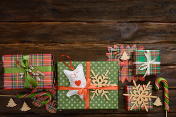 Christmas present boxes decorated with colorful paper on wooden