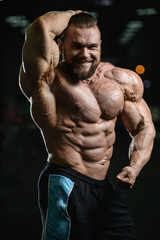Fototapeta premium Brutal strong bodybuilder athletic men pumping up muscles with d