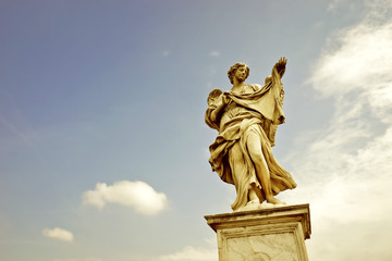 The statue of angel figure on the Aelian Bridgein in Rome in a sunny day.
