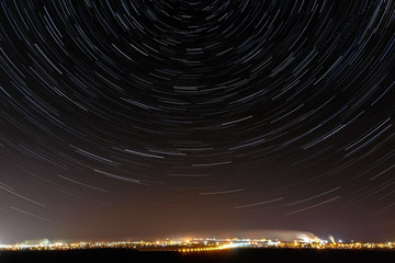 Stars of  night sky. City street light illuminated. Starry track