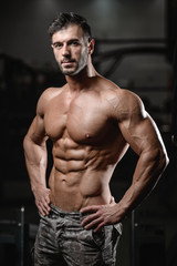 Strong and handsome athletic young man muscles abs and biceps.