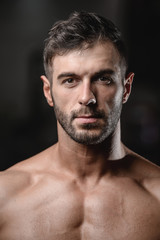 Handsome men face close up portrait in the gym