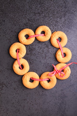 Christmas wreath: cookies decorated with a red ribbon . Christmas decoration. Black background