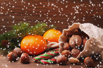 Christmas spirit: nuts, tangerines, Christmas tree, nuts, a flas