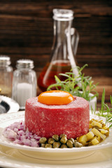 Beef tatare with egg, onion, cucumber and capers