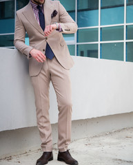 Male model in a suit posing otdoors