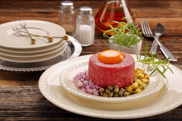 Beef tatare with egg, onion, cucumber and capers