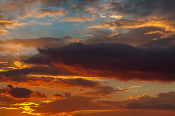 Beautiful cloudy sky illuminated by the sun at sunset