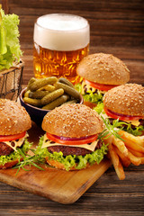 Hamburger with beef meat and fresh vegetables on wooden backgrou