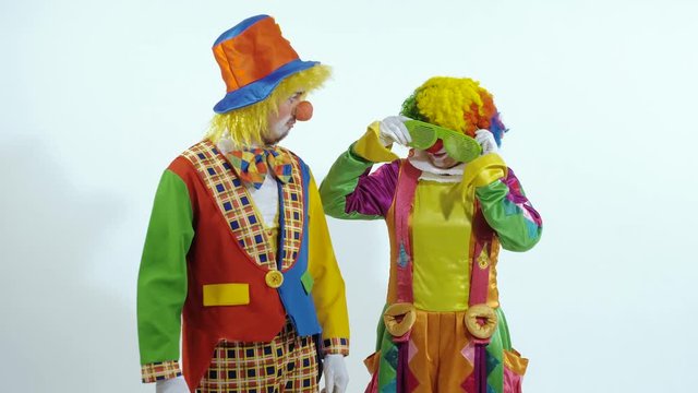 Portrait of a couple of circus clowns dancing in funny way