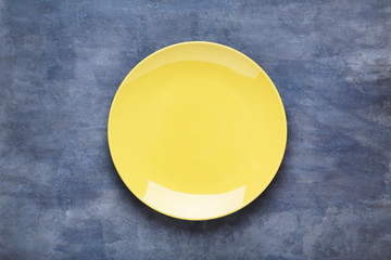 Empty plate on grey wooden table