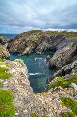 Cape Bonavista featuring coastal slabs of stone boulders and rocks that show their layers of formation over millions of years.  Rocky boulder shoreline in Newfoundland, Canada.