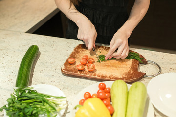 Woman's hands cutting vegetables.
