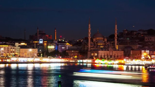 Istanbul, Turkey time-lapse at night. Aerial view of harbor with ships going down the river Bosporus in Istanbul, Turkey. Historical part of the city during, famous bridge and mosques.