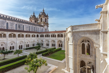 Fototapeta na wymiar Courtyard garden of Catholic monastery tower in the background.