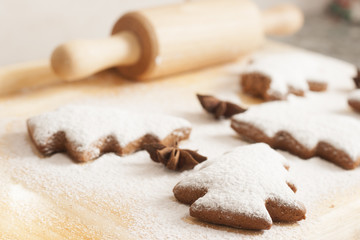 Fototapeta na wymiar christmas gingerbread cookies baking process , dough and rolling pin,shallow depth of field.