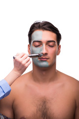 Man with face mask being applied on white