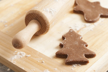 christmas gingerbread cookies baking process , dough and rolling pin,shallow depth of field.