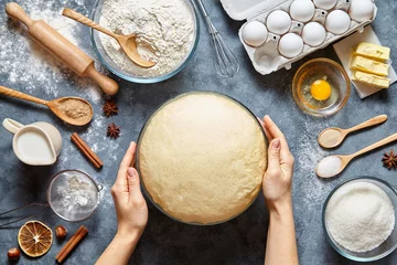 Poster Hands working with dough preparation recipe bread, pizza or pie making ingridients, food flat lay on kitchen table background. Butter, milk, yeast, flour, eggs, sugar pastry or bakery cooking. © GreenArt Photography