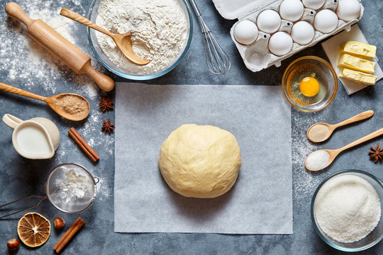 Dough mixing recipe bread, pizza or pie making ingridients, food flat lay on kitchen table background. Working with butter, milk, yeast, flour, eggs, sugar pastry or bakery cooking.