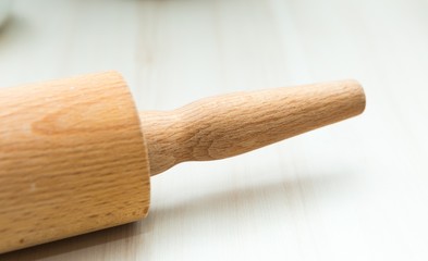 Close up of rolling pin lying on wooden table