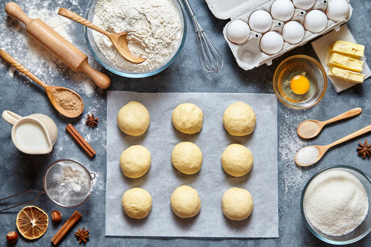 Buns dough mixing recipe bread, pizza or pie making ingridients, food flat lay on kitchen table background. Working with butter, milk, yeast, flour, eggs, sugar pastry or bakery cooking.