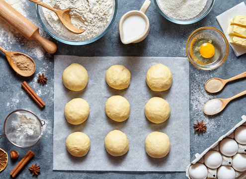 Buns dough preparing recipe bread or pie making ingridients, food flat lay on kitchen table background. Working with butter, milk, yeast, flour, eggs, sugar pastry or bakery cooking.