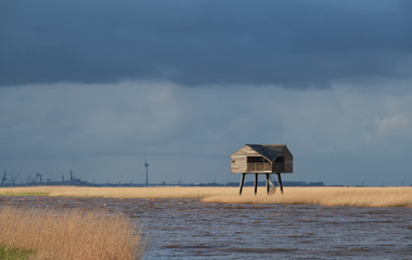 Fototapeta na wymiar wooden tower on Wadden sea coast