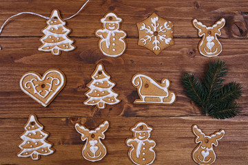 Christmas tree decoration made from gingerbread cookies on wooden table. New year background