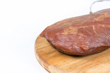 Smoked pork meat isolated on wooden board