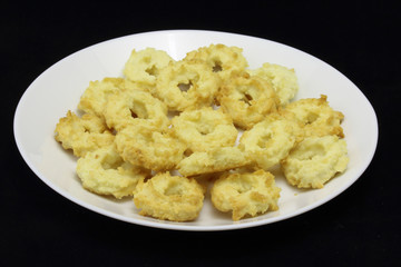 Isolated white plate with special czech christmast cookies, x-mas sweets like butter tea cookies, made of butter and coconut