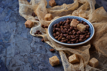 Bowl of coffee beans and brown cane sugar