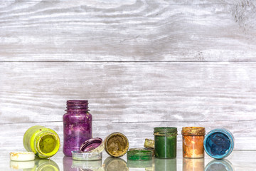 Multicolored plastic cans with paints. Artist workplace background. Old dirty Paints background. Colorful artist palette. Creativity, visual art concept. Art and craft.