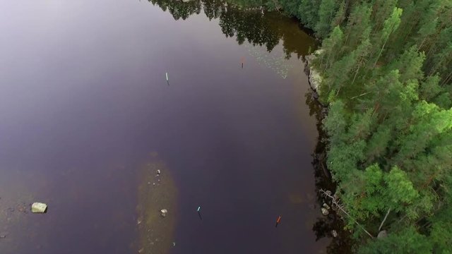Aerial shot of moving above a strait sea lane at a Finnish lake