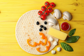 Raw pizza ingredients on wooden background, top view