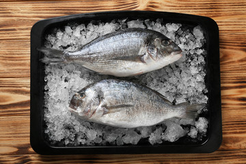 Raw fish with ice in baking tray