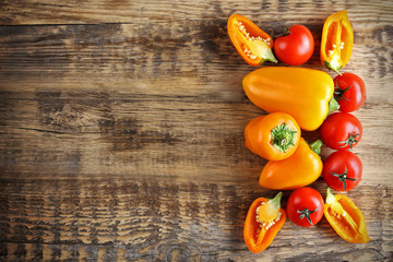 Fresh vegetables on wooden background, top view