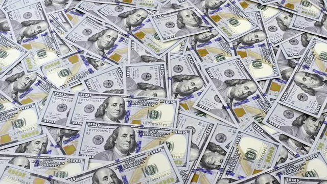 Table covered with dollar banknotes, camera tracking