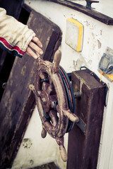 Persons hand on old rudder © Mario Hoppmann