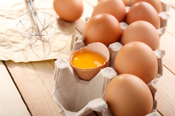 Eggs package  with whisk, closeup
