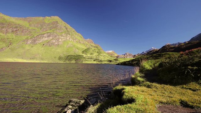 View of lake Ritom in Piora near Gotthard, Canton Ticino of Switzerland with Swiss Alps in the background, Switzerland, Europe. 
