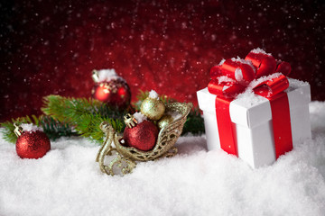 christmas gift with balls bow red background