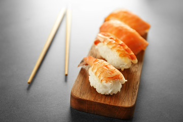 Delicious sushi set on wooden board