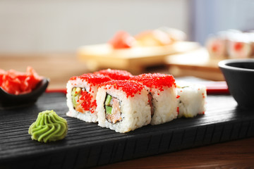 Delicious sushi set on wooden board