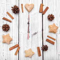 Christmas pine cone watch decoration on white wooden board