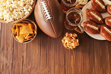 Table full of tasty snacks and beer prepared for watching rugby on TV - obrazy, fototapety, plakaty